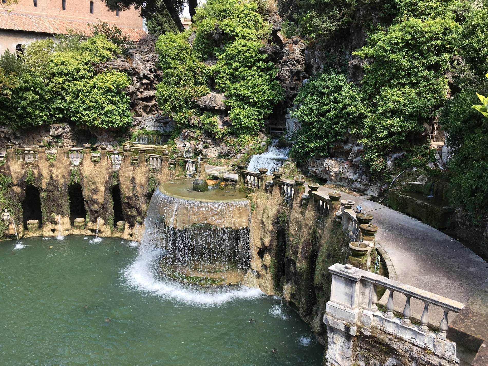 View of the The Oval Fountain (Fontana dell'Ovato) and statue of the Sibyl Albunensa viewed from the terrace above. Looking down on the Oval Fountain in the terraced gardens of Villa d'Este in Tivloli